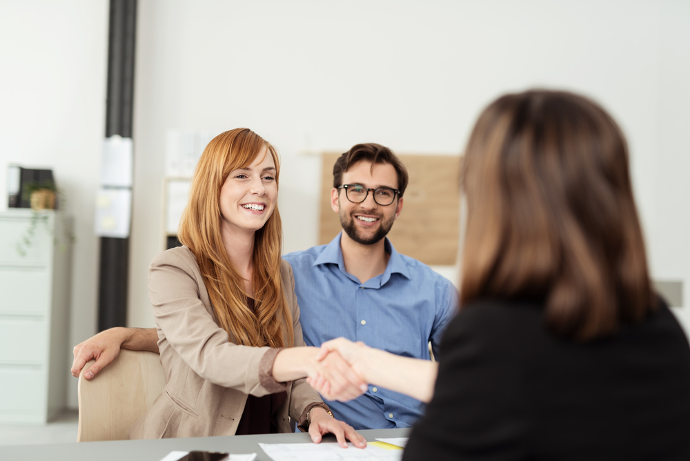 Image of a Customer Service Rep greeting a set of new clients.