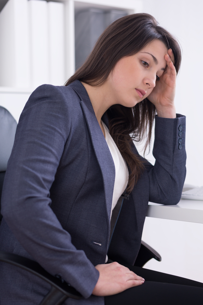 Image of a women experiencing fatigue at the workplace.