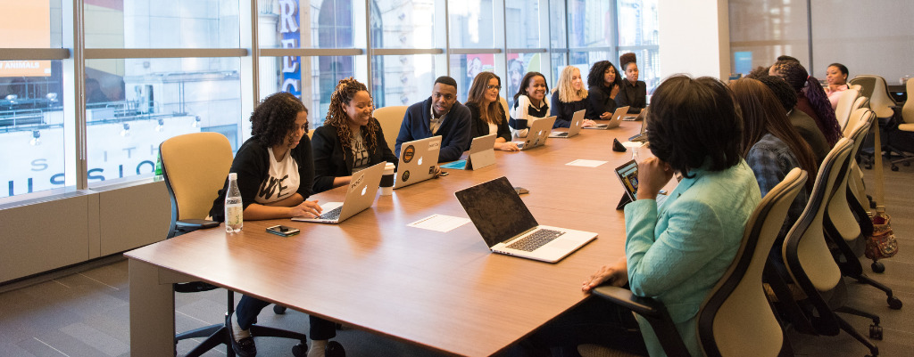 People sit around a large table for a career networking conference